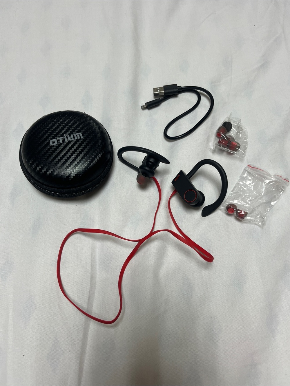 NWOT OTIUM Bluetooth sports earbuds